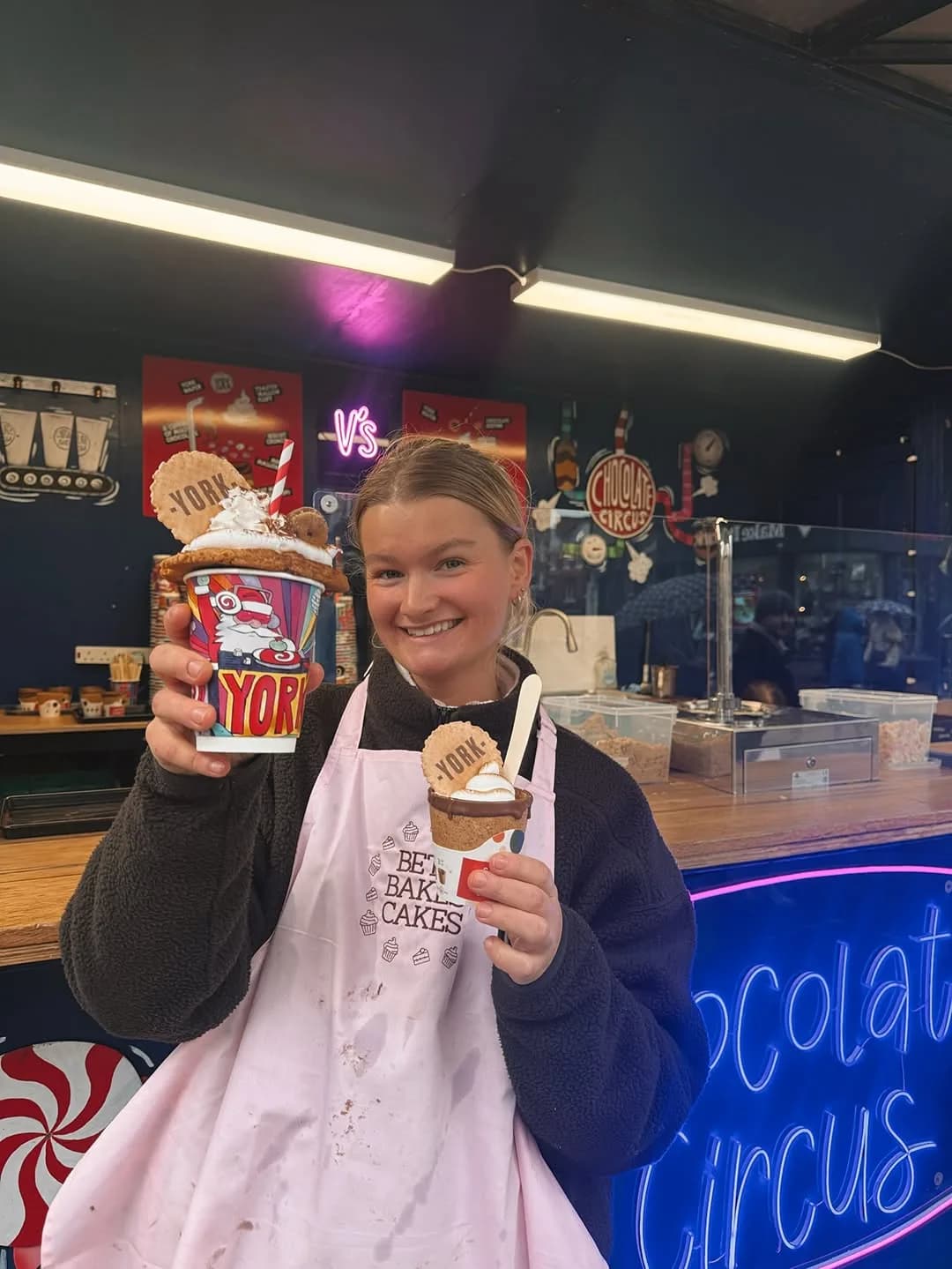 Beth holding Chocolate Circus hot chocolates topped with her cookies