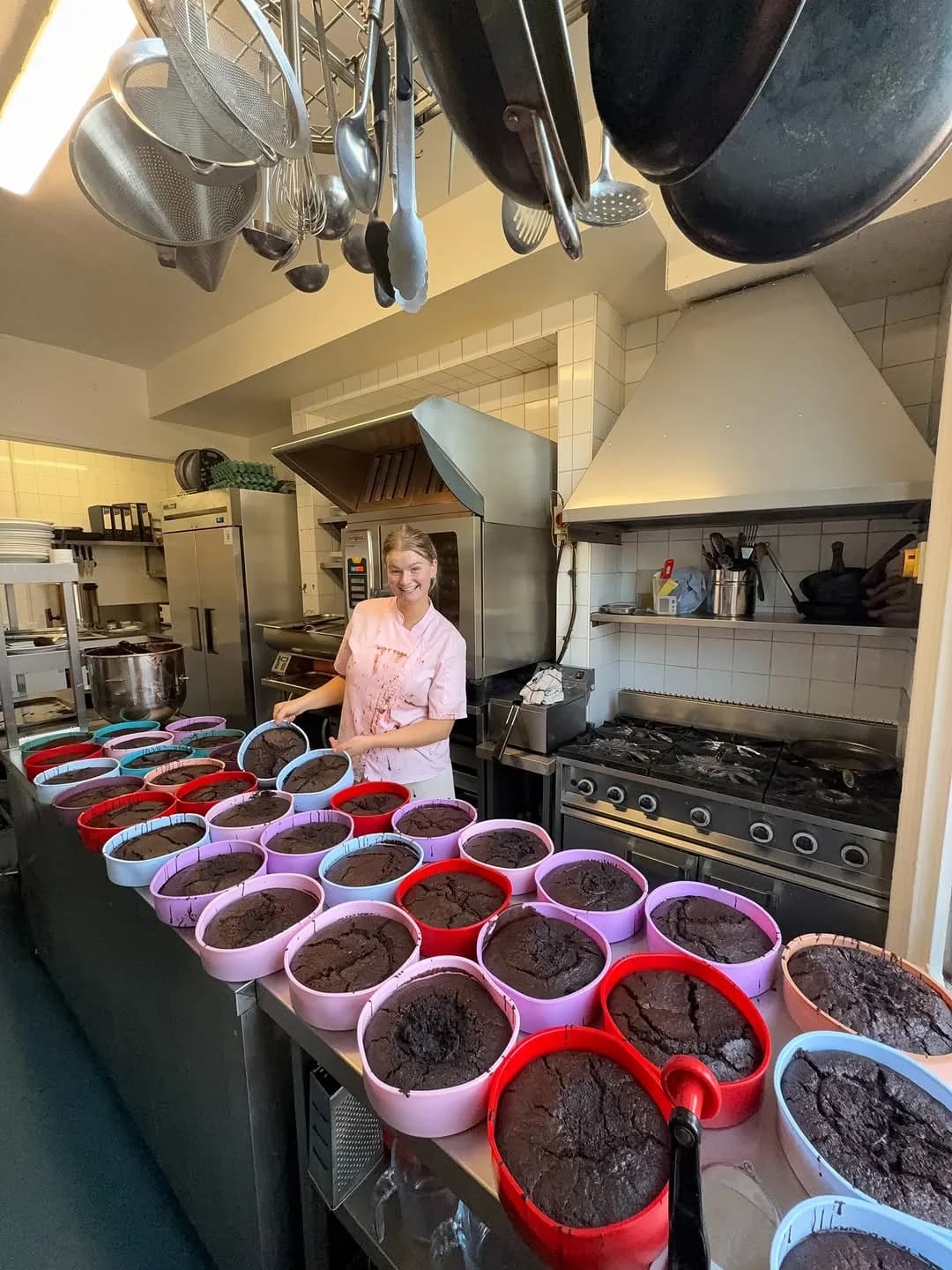 Beth mass-baking chocolate cakes in the kitchen for the market