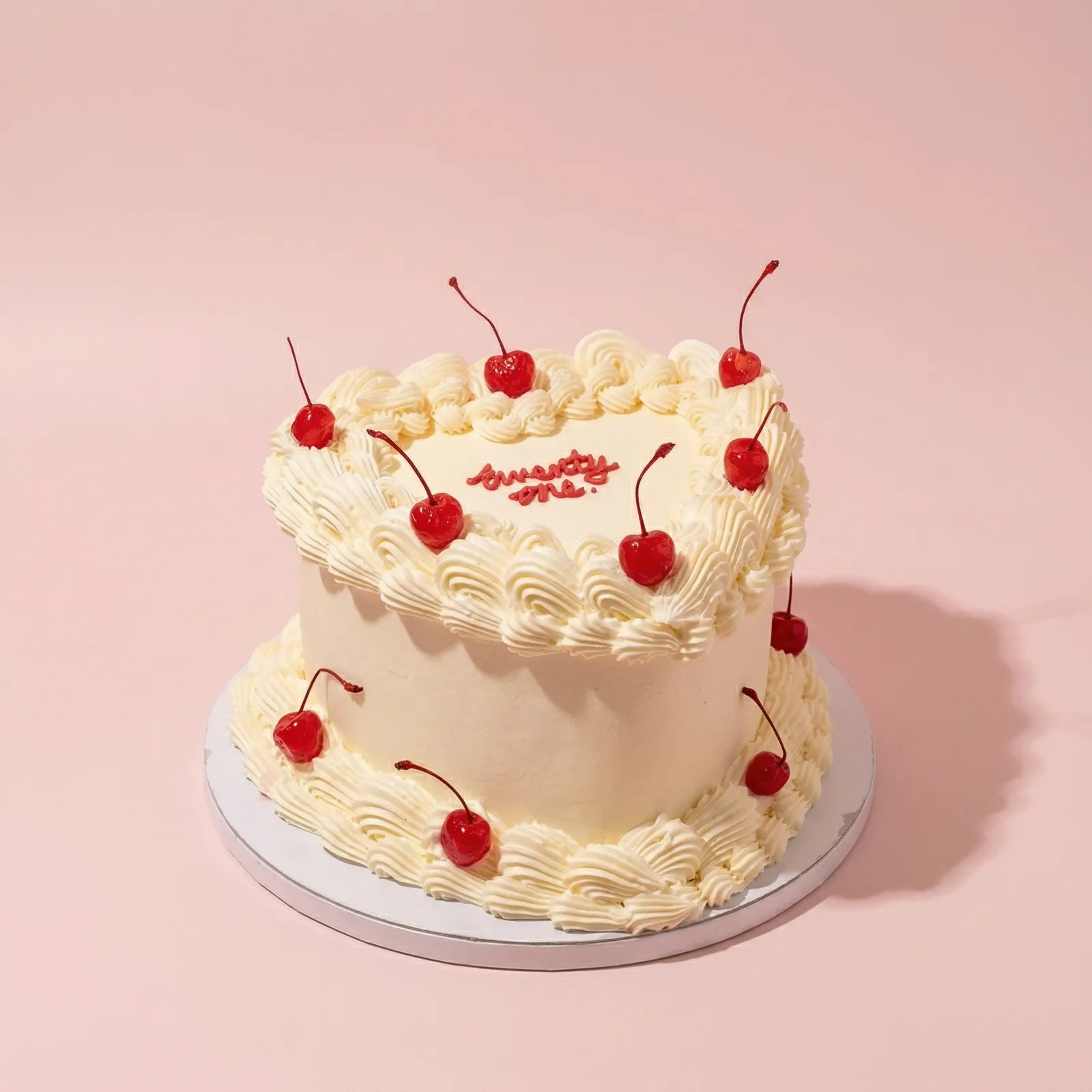 Classic cream Lambeth heart cake with cherries
