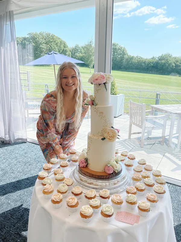 Beth setting up a wedding cake at a country venue